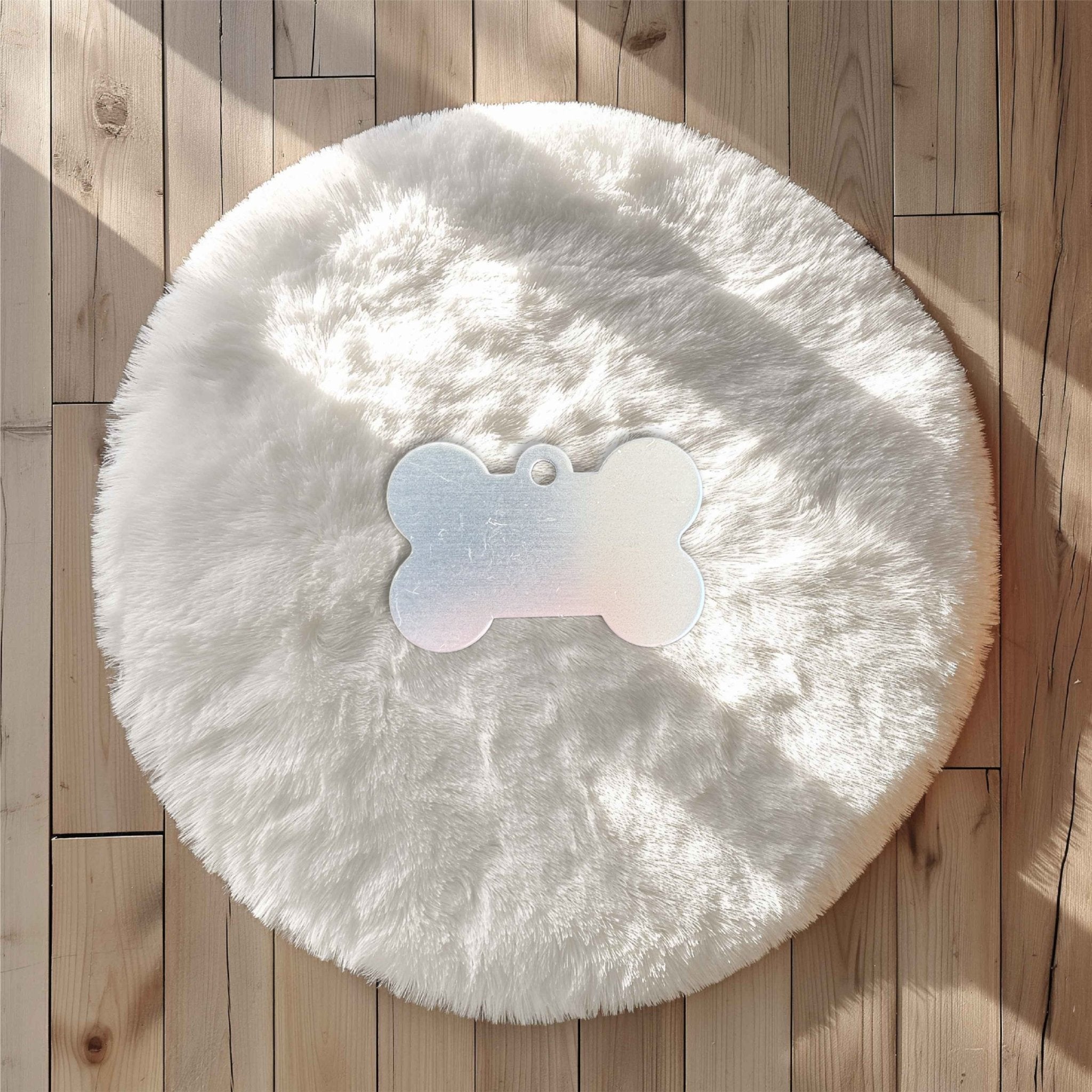 Iridescent bone-shaped pet tag on a white fluffy surface – personalised metal pet name tag – Etch 'N' Shine