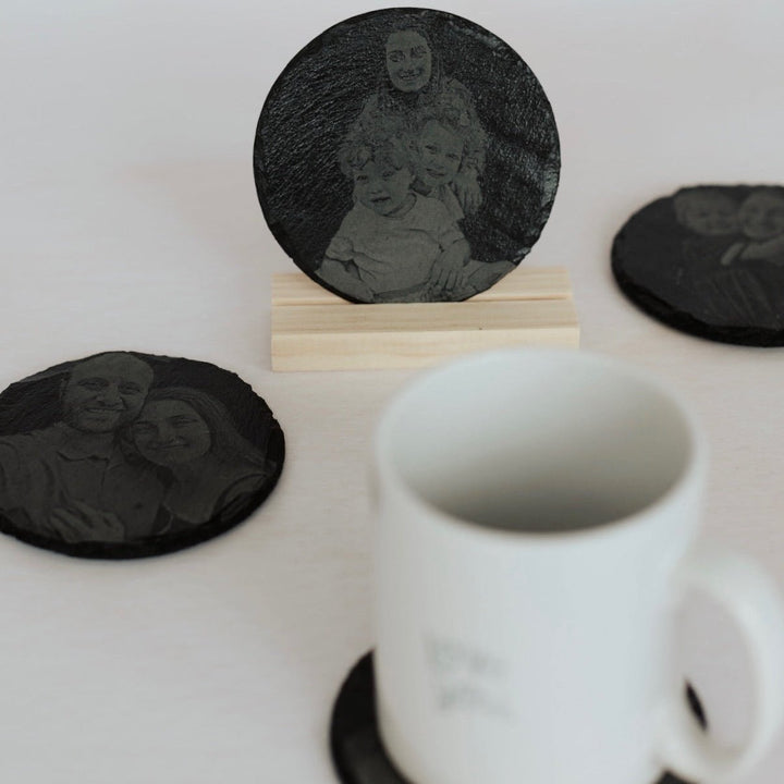 Round slate coasters with engraved photo portrait, shown with a mug – personalised slate coaster – Etch 'N' Shine
