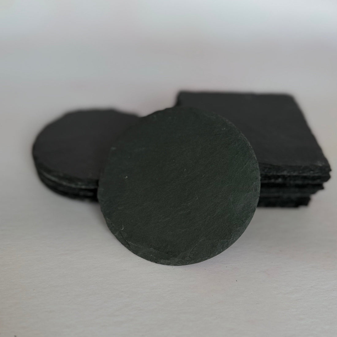 Round and square slate coasters stacked together, plain finish – personalised slate coaster set – Etch 'N' Shine