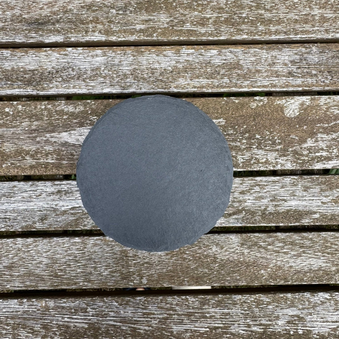 Plain round slate coaster on weathered wooden decking – slate coaster – Etch 'N' Shine