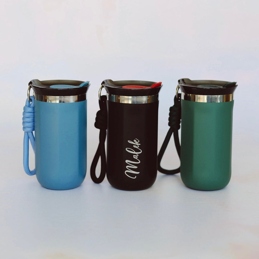 Three colour variants of engraved steel travel mug with rope handle – personalised insulated mug – Etch 'N' Shine