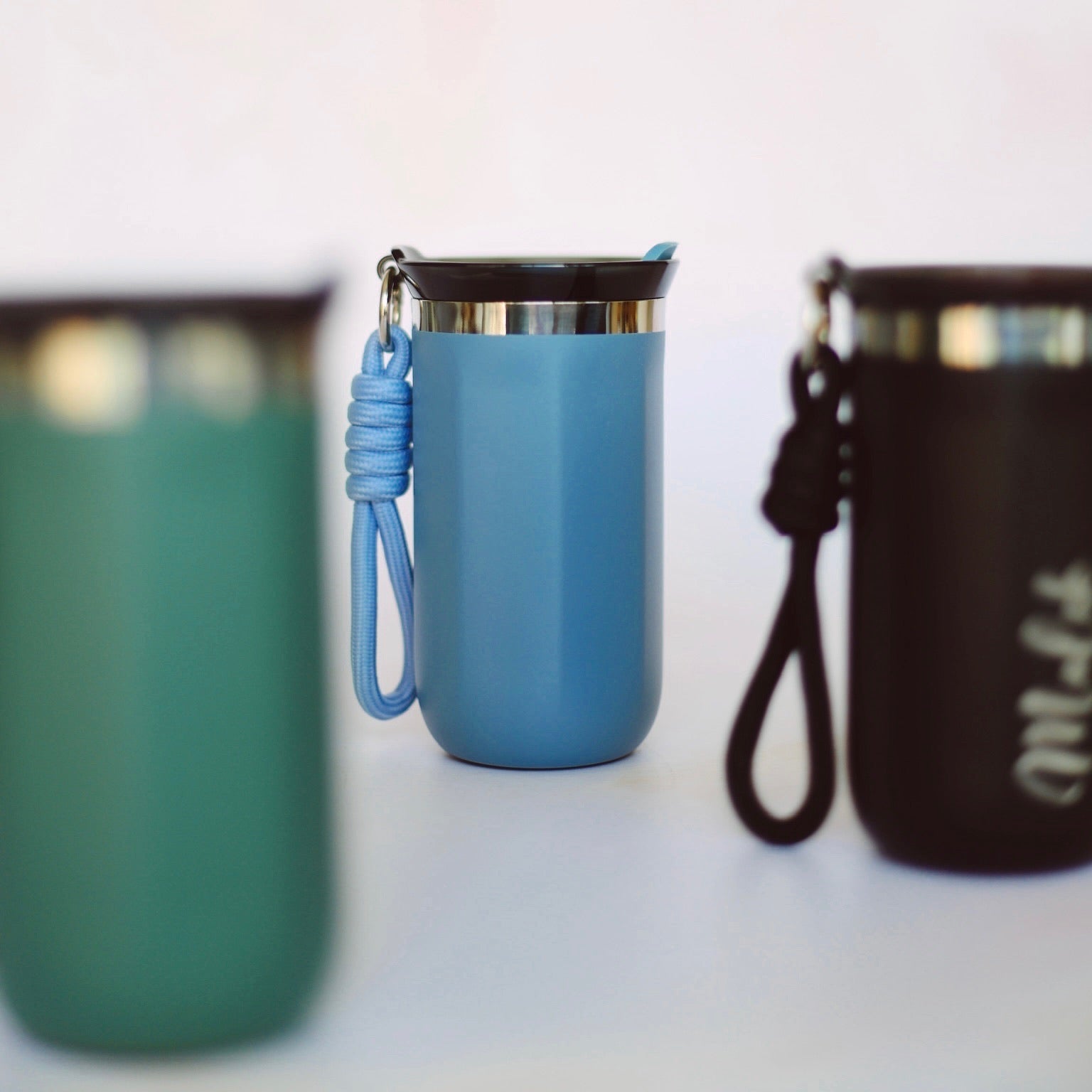 Three colour variants of engraved steel travel mug with rope handle – Etch 'N' Shine