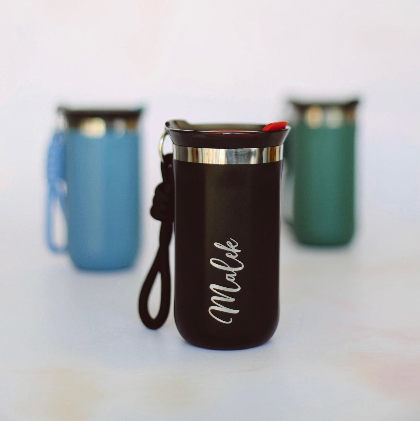 Three colour variants of engraved travel mug with custom name – personalised steel coffee mug – Etch 'N' Shine