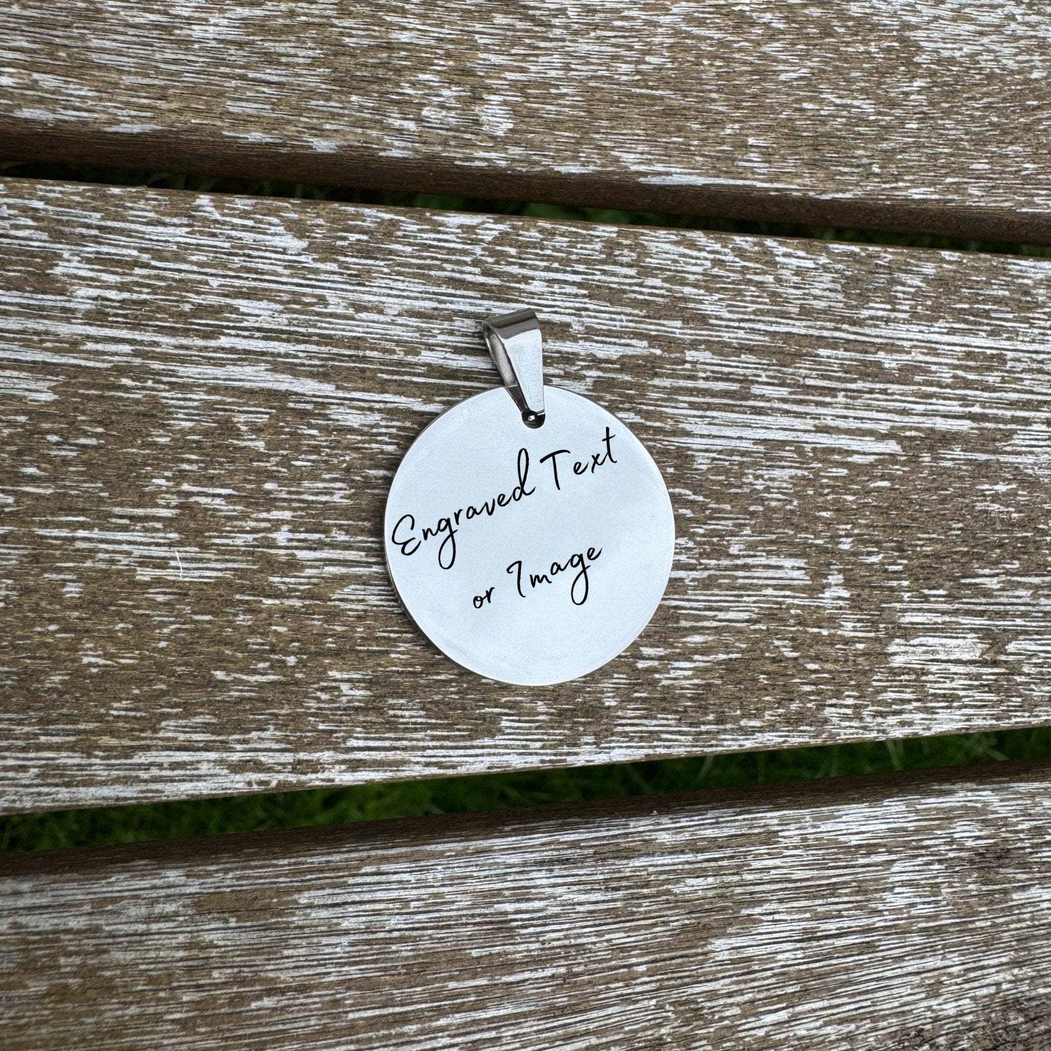 Round mirror-polished pendant with custom text on wooden surface – personalised stainless steel pendant – Etch 'N' Shine