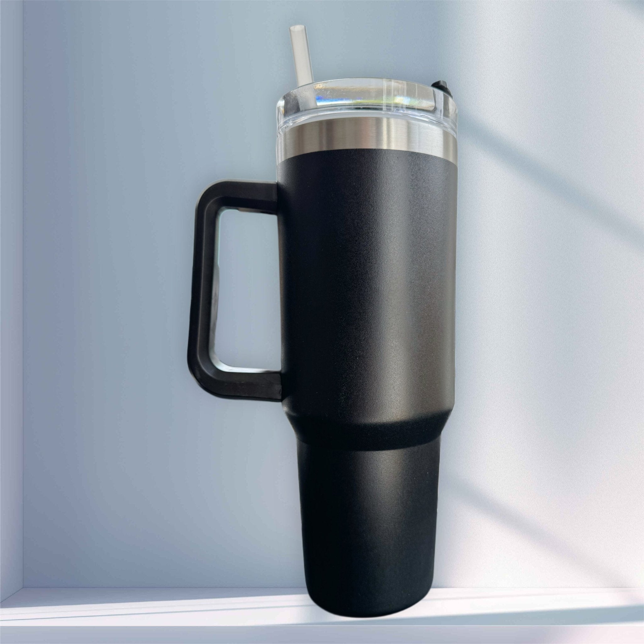 Black matte tumbler with handle and straw lid on a shelf – personalised stainless steel tumbler – Etch 'N' Shine