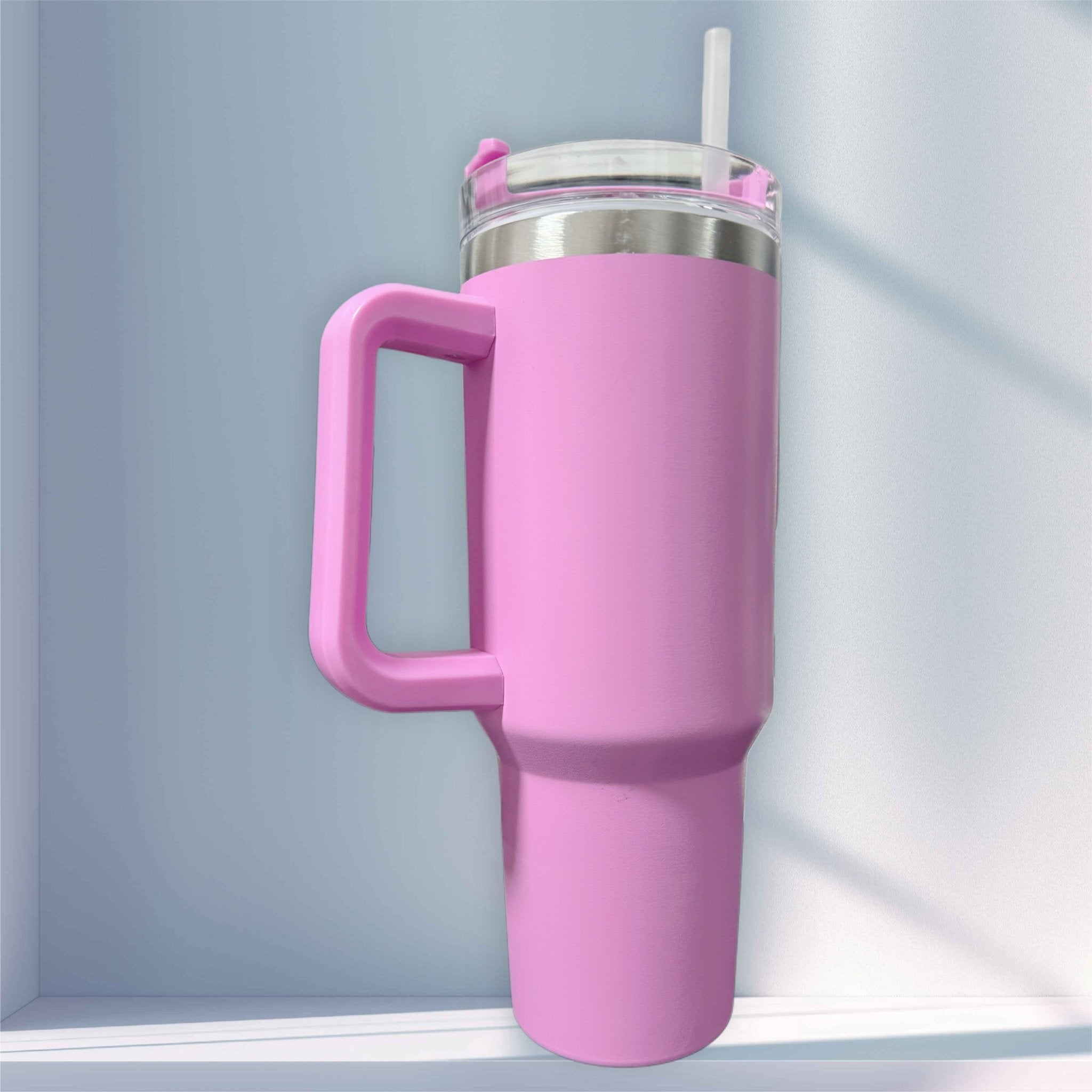 Pink handled tumbler with clear lid and straw on a shelf – personalised stainless steel tumbler – Etch 'N' Shine
