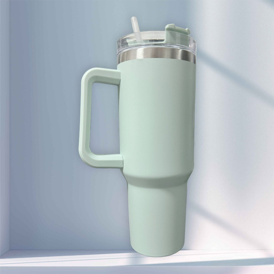 Sage green handled tumbler with straw lid on a shelf – personalised stainless steel tumbler – Etch 'N' Shine