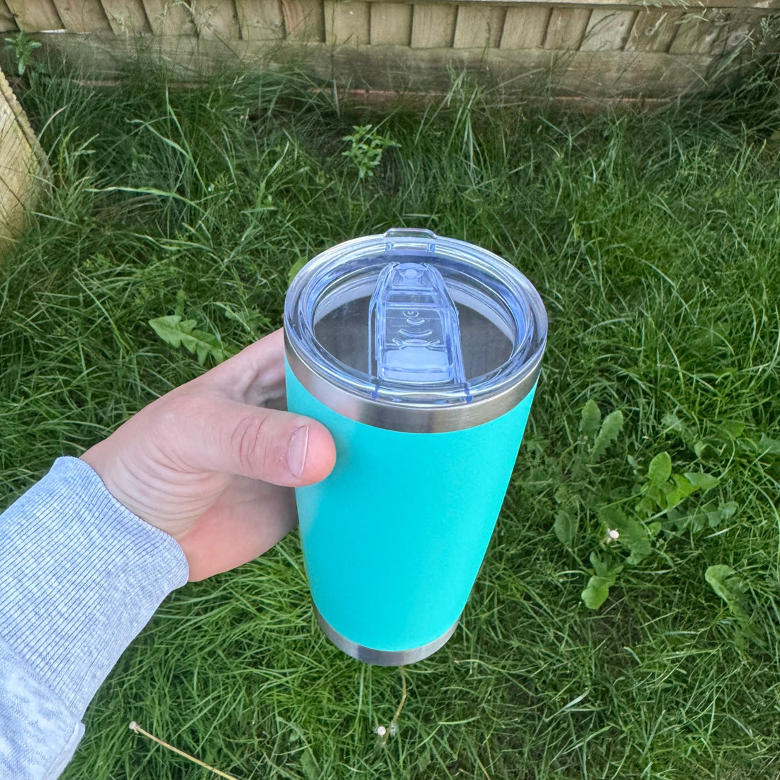 Teal insulated tumbler with clear sliding lid held outdoors – personalised stainless steel tumbler – Etch 'N' Shine