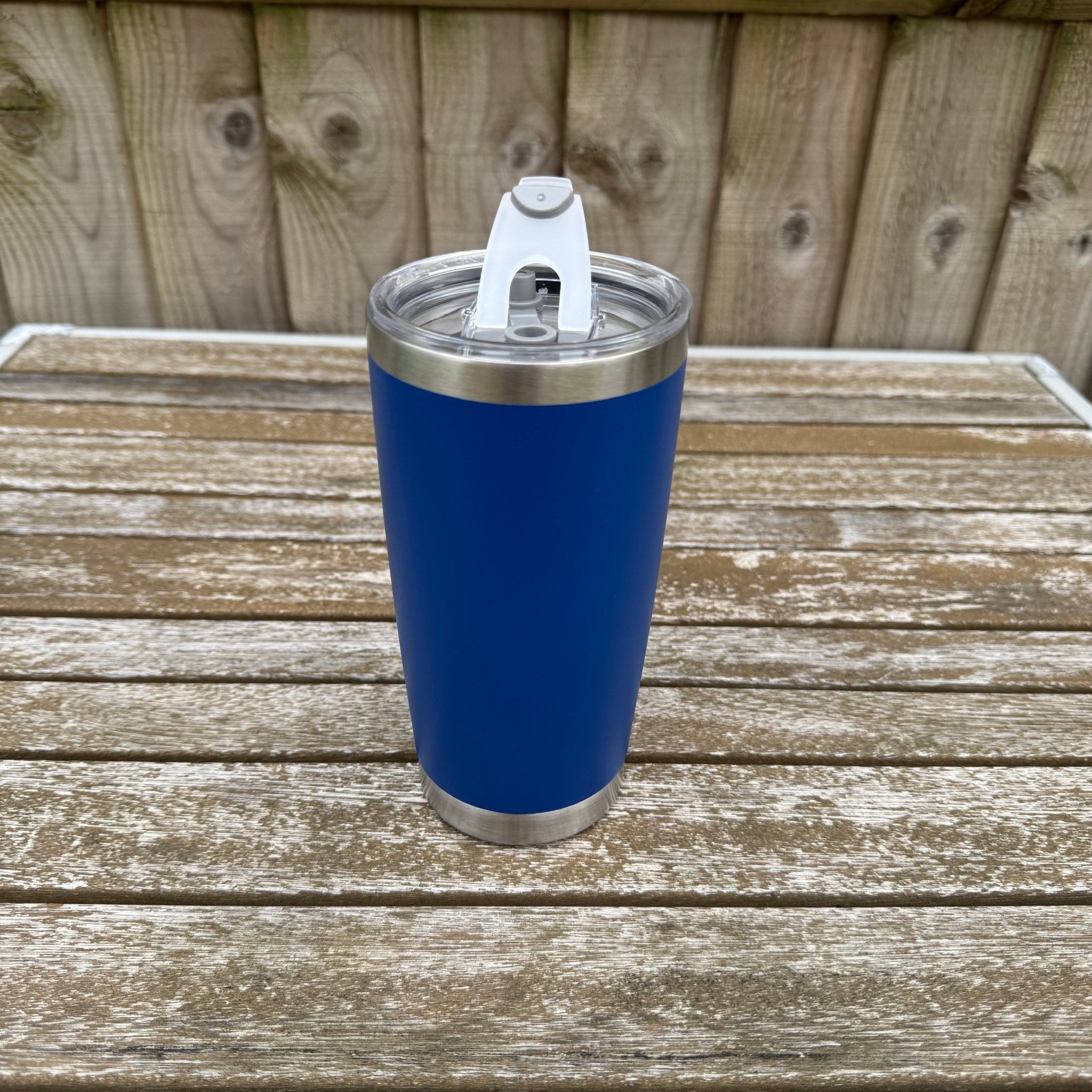 Blue insulated tumbler with sliding lid on a wooden outdoor table – personalised stainless steel tumbler – Etch 'N' Shine