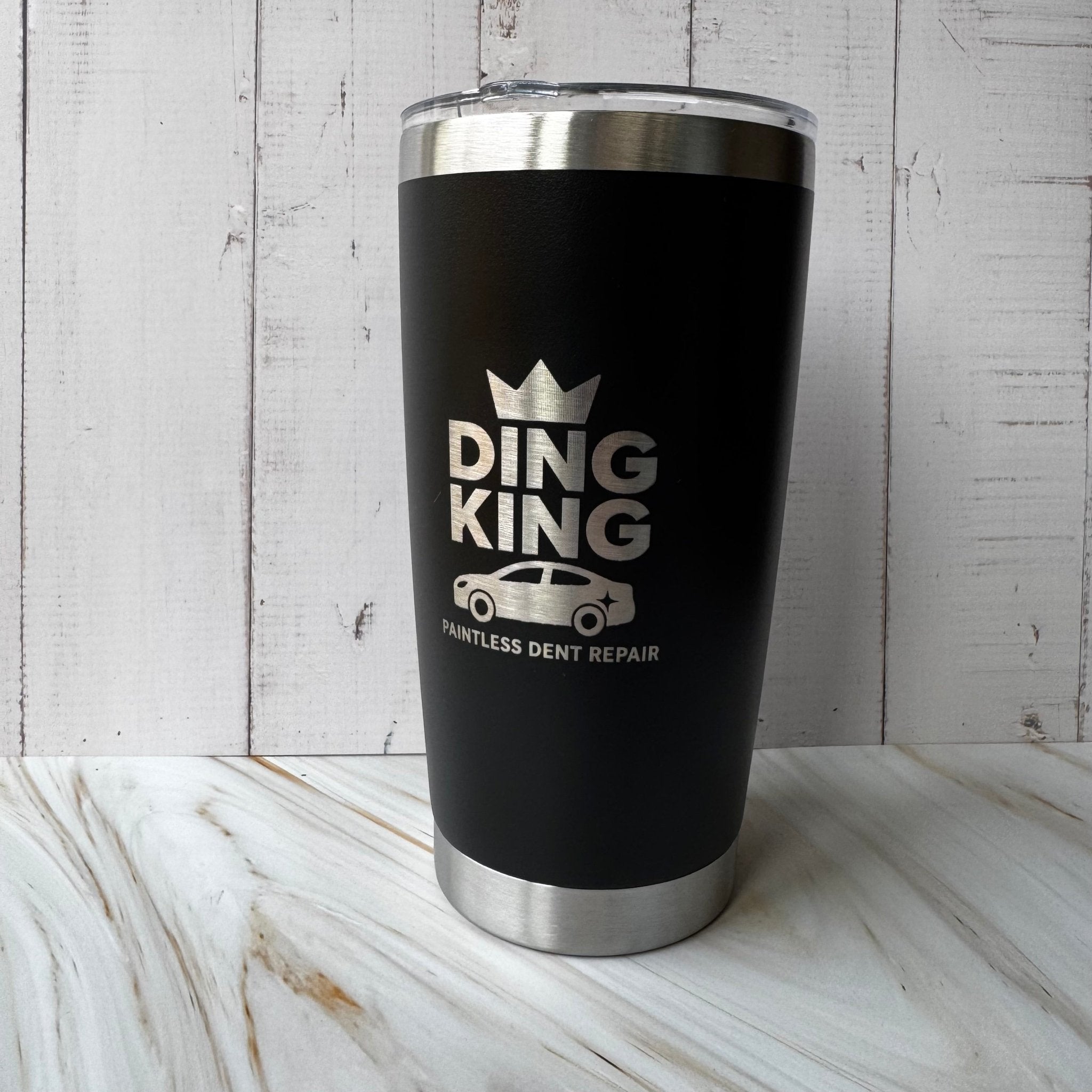 Black insulated tumbler with engraved custom logo on a wooden surface – personalised stainless steel tumbler – Etch 'N' Shine