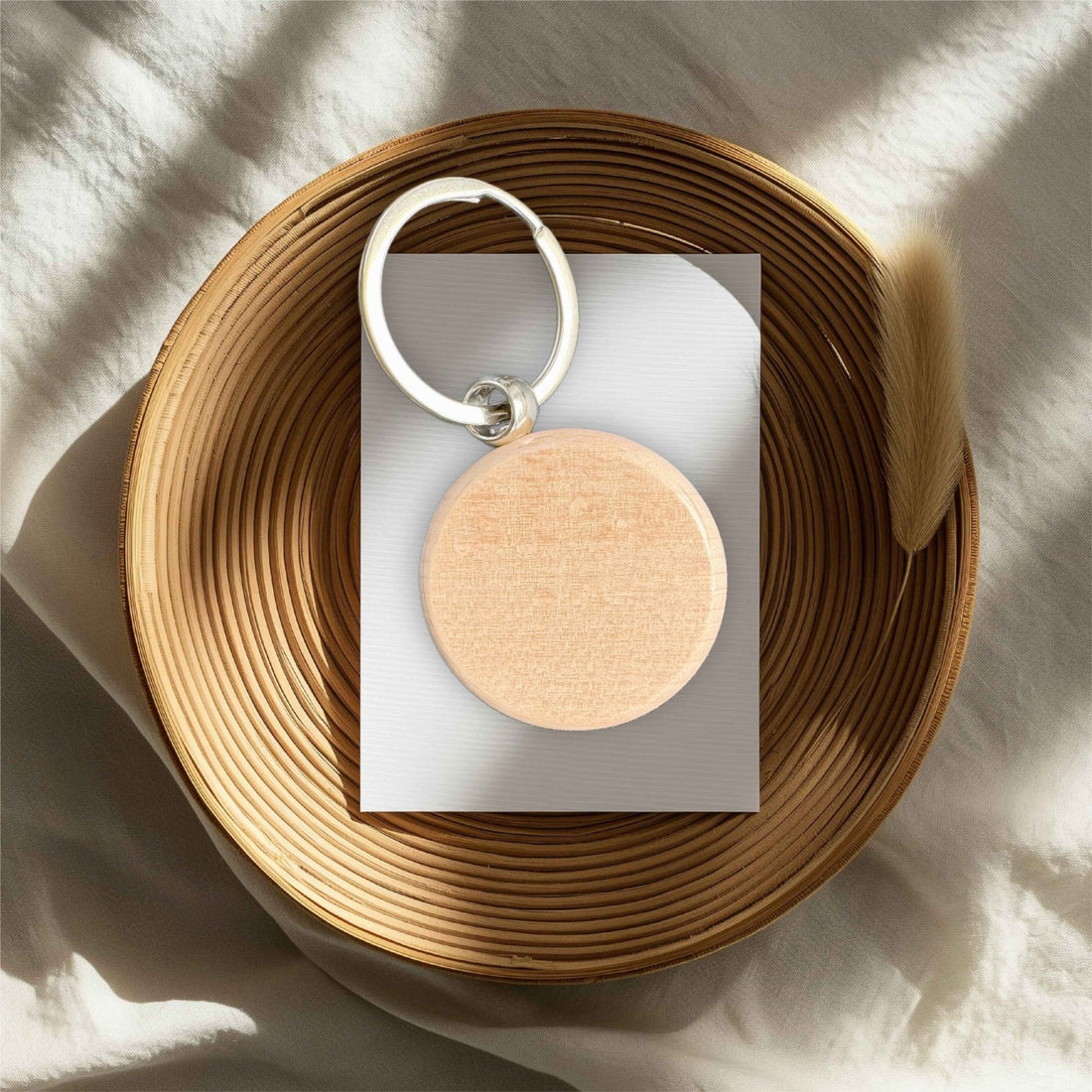 Round wooden disc keyring in wicker bowl – personalised engraved wooden keyring – Etch 'N' Shine
