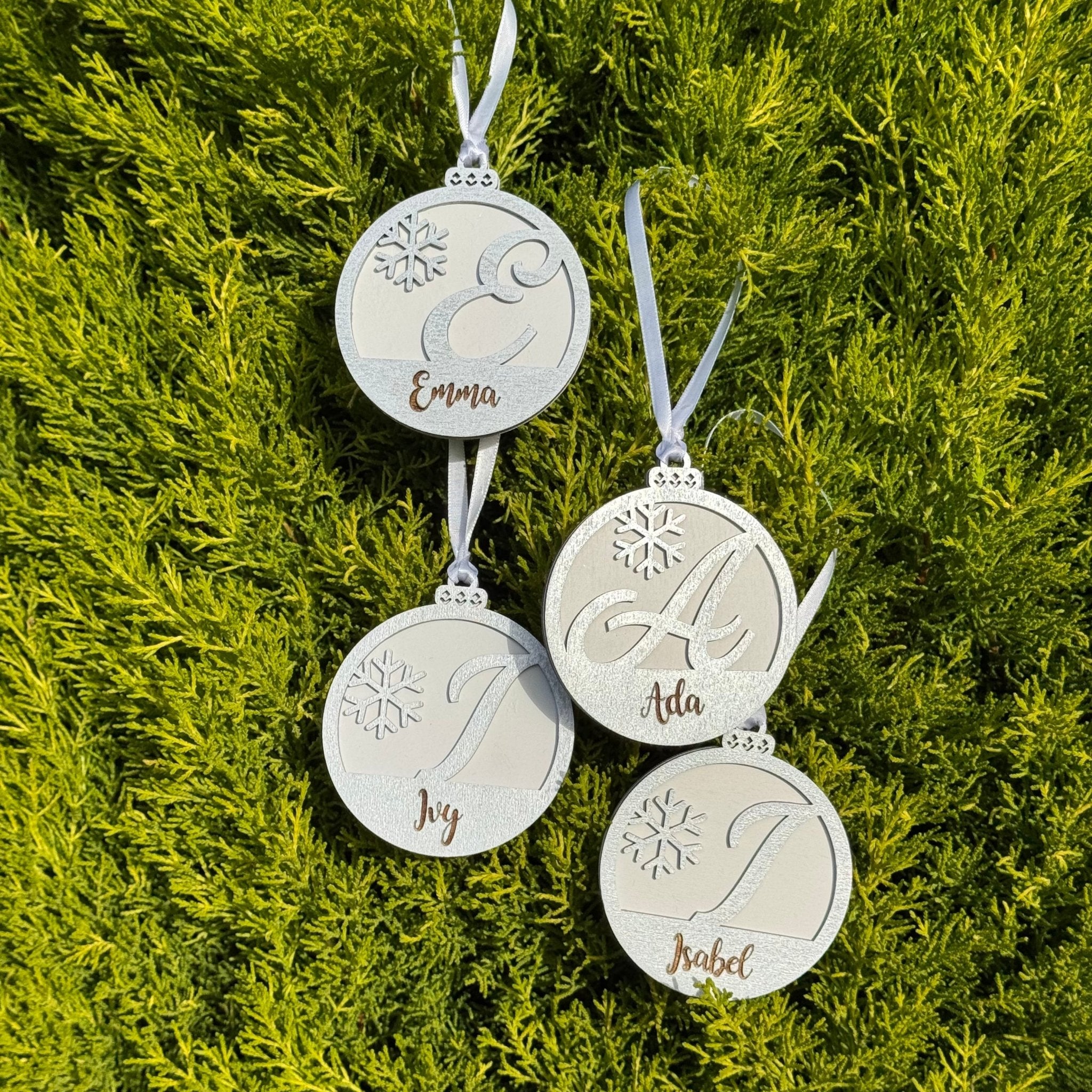Four engraved wooden baubles with custom names and initials – personalised Christmas ornaments – Etch 'N' Shine