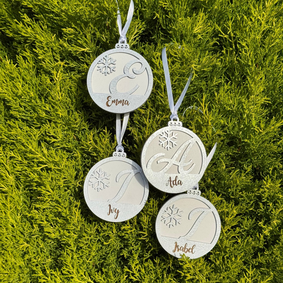 Four engraved wooden baubles with custom names and initials – personalised Christmas ornaments – Etch 'N' Shine