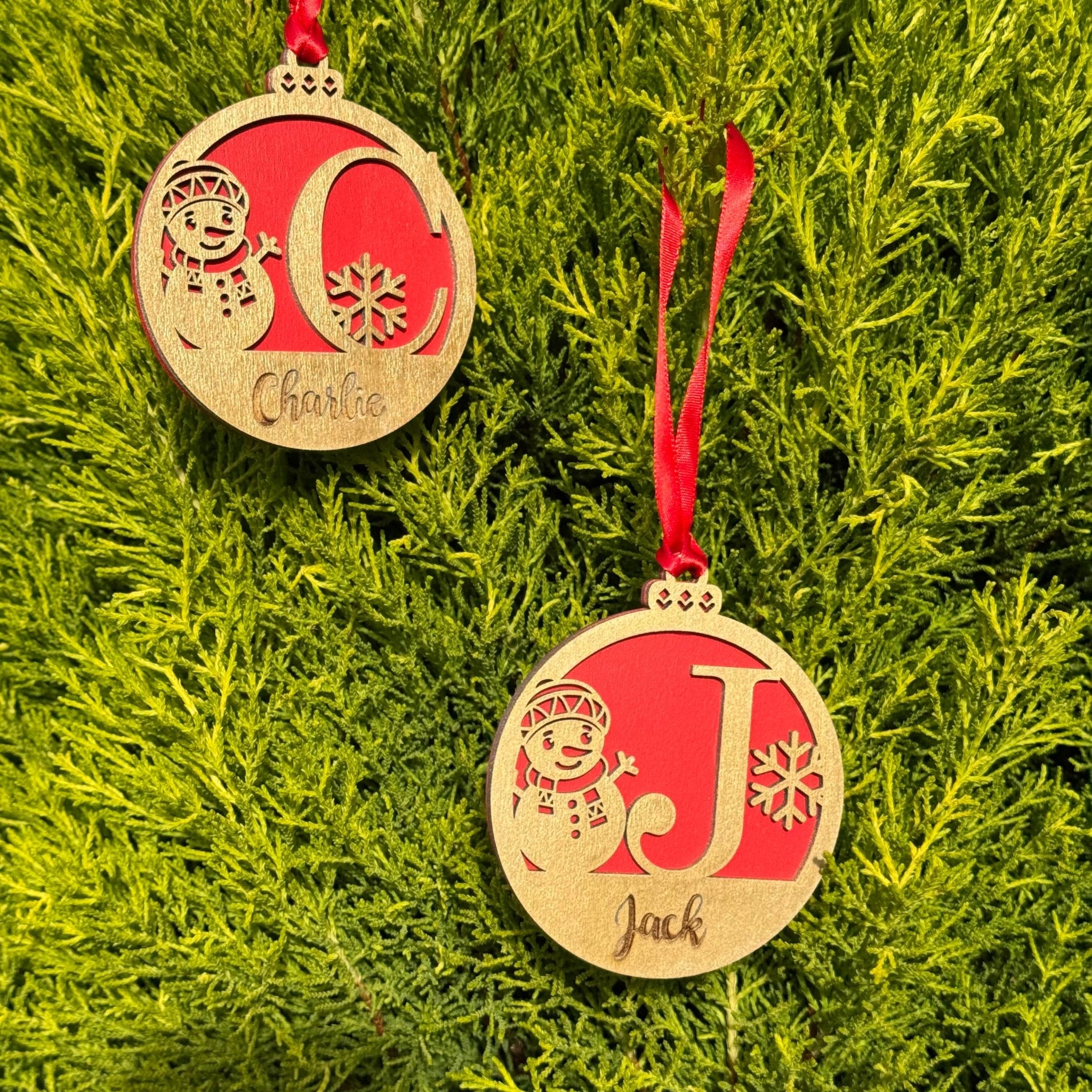 Two wooden baubles with custom initials and names on red backing – personalised Christmas ornaments – Etch 'N' Shine
