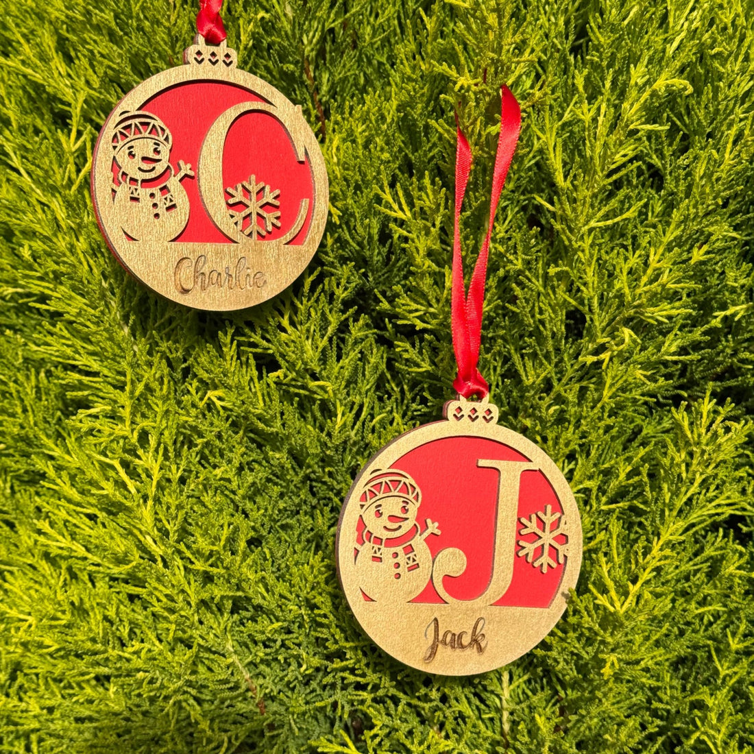 Two wooden baubles with custom initials and names on red backing – personalised Christmas ornaments – Etch 'N' Shine