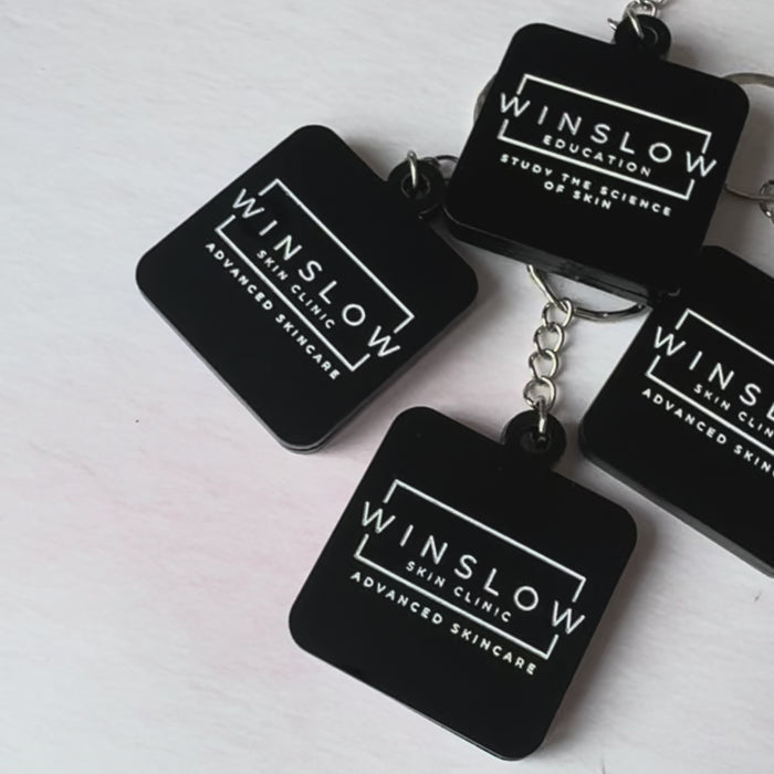 Video of black acrylic NFC keyrings engraved with the Winslow Skin Clinic logo – Etch 'N' Shine
