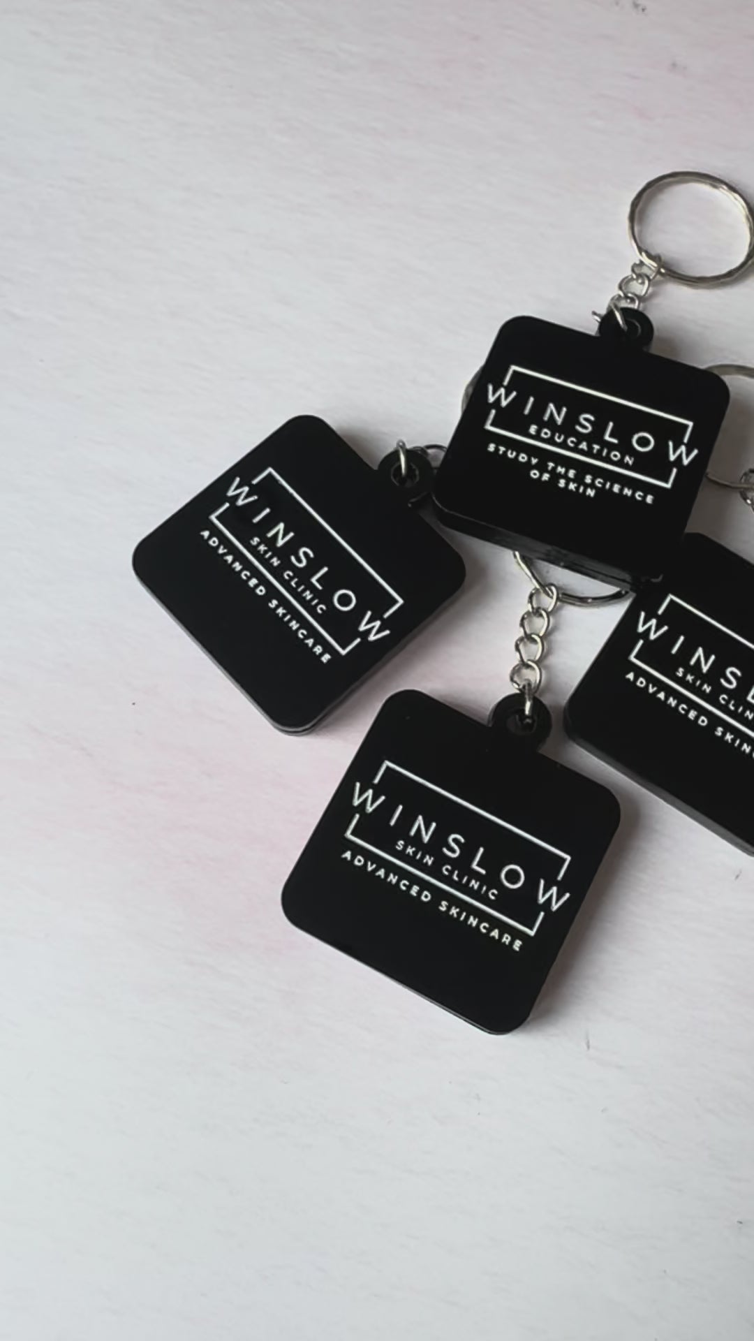 Video of black acrylic NFC keyrings engraved with the Winslow Skin Clinic logo – Etch 'N' Shine