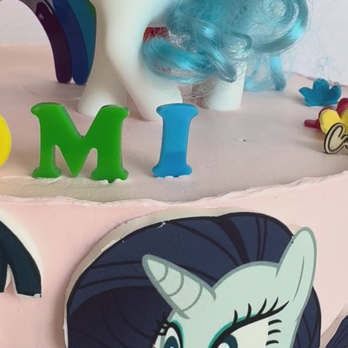 Video of the rainbow number and name topper set on a finished birthday cake – Etch 'N' Shine