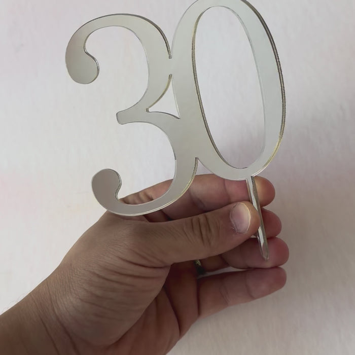 Video of a silver mirror acrylic number 30 cake topper catching the light – Etch 'N' Shine