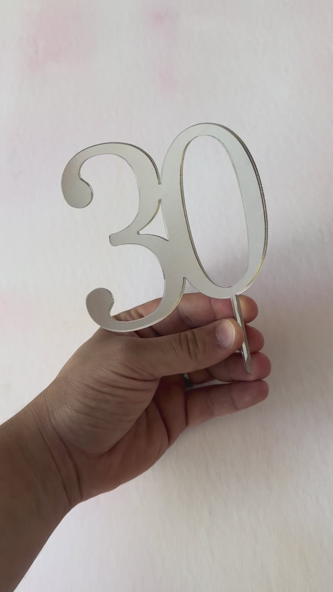 Video of a silver mirror acrylic number 30 cake topper catching the light – Etch 'N' Shine