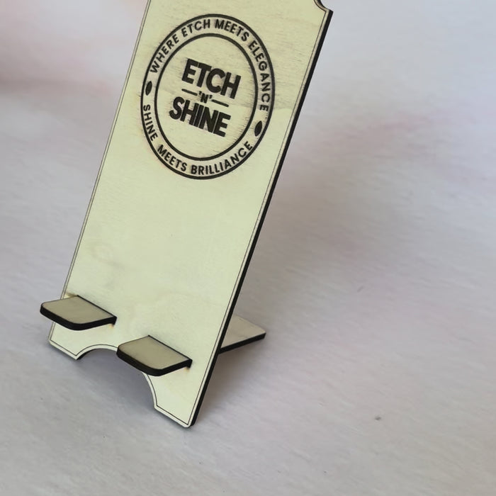 Video of a phone being placed in a personalised wooden phone stand – Etch 'N' Shine