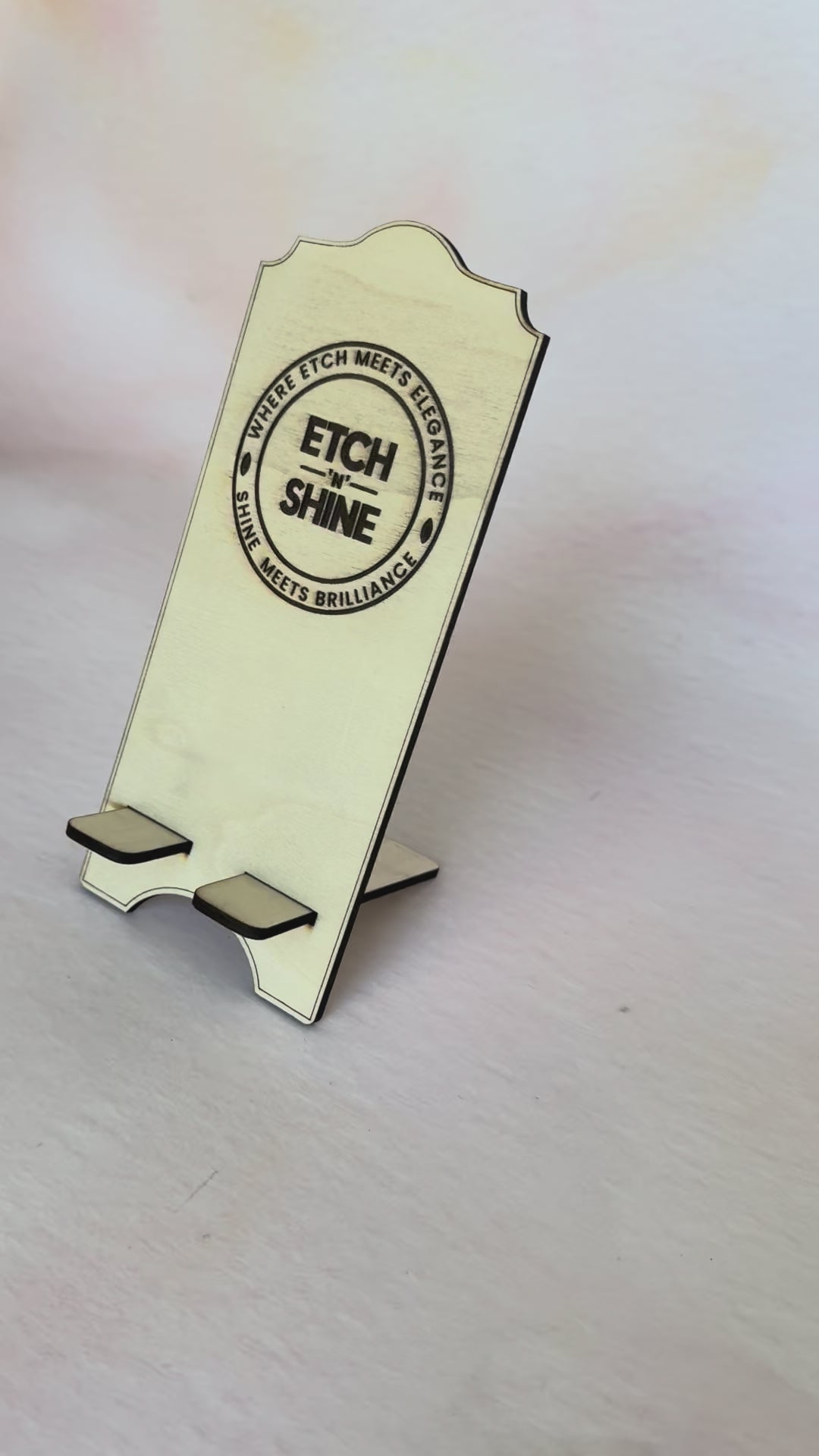 Video of a phone being placed in a personalised wooden phone stand – Etch 'N' Shine