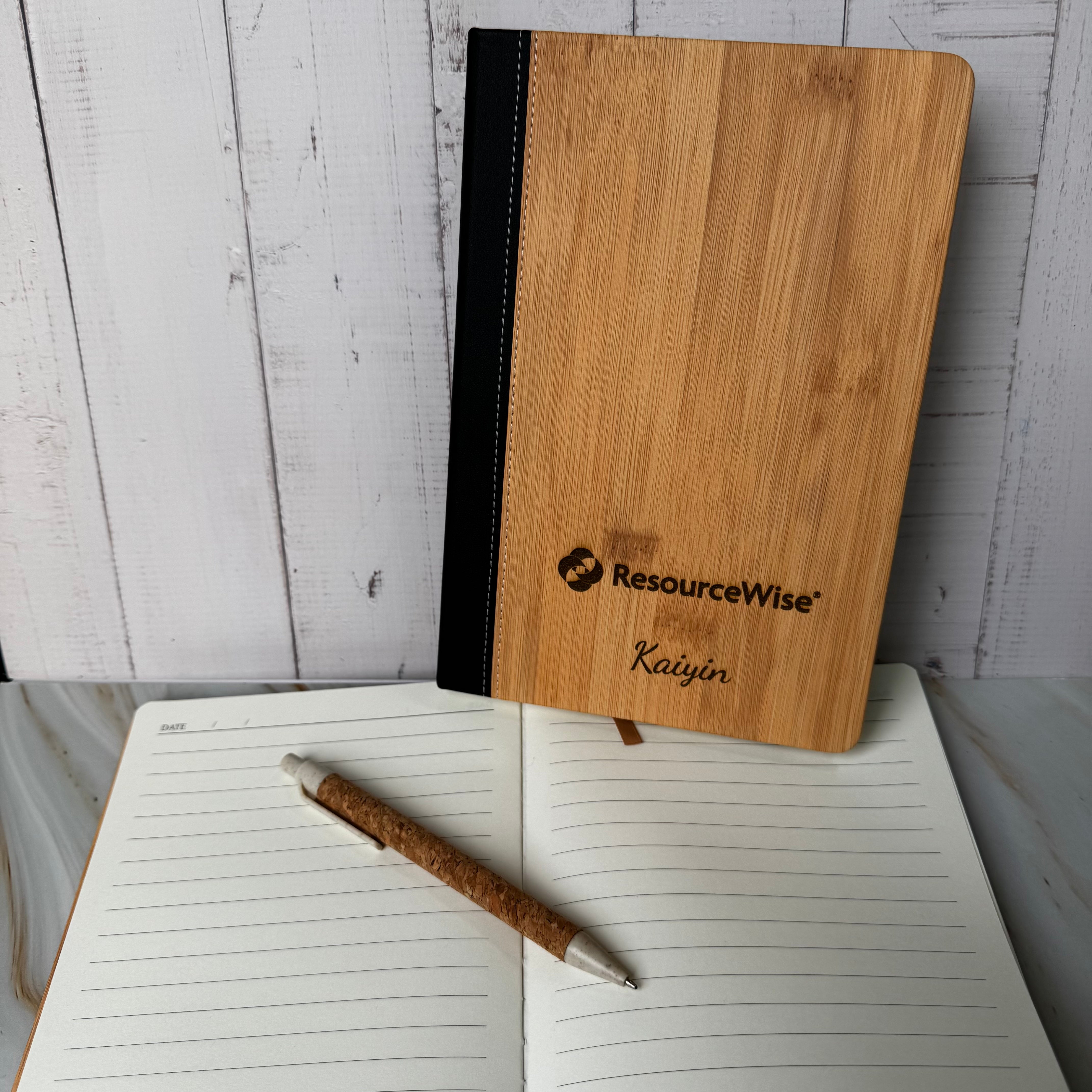 Wooden notebook with 'ResourceWise' branding on a white surface