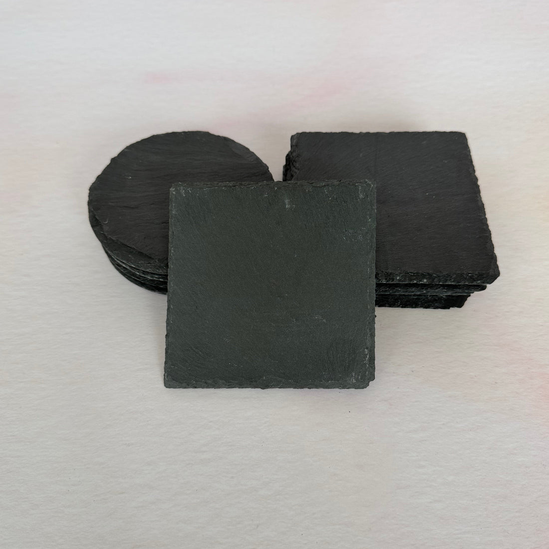 Black decorative wall piece on a light gray background