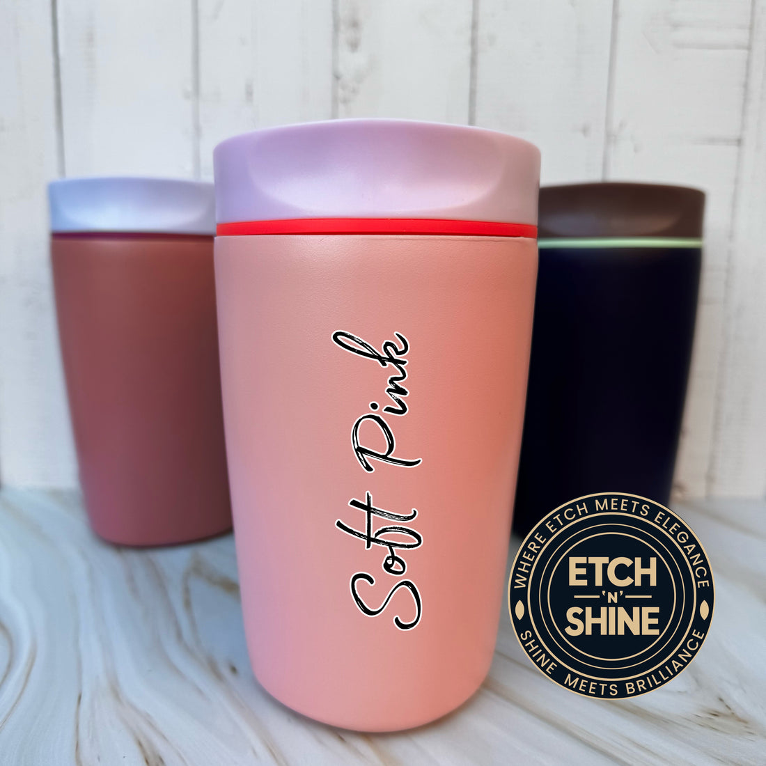 Pink tumbler with 'Soft Pink' text and 'ETCH N SHINE' logo on a wooden surface.
