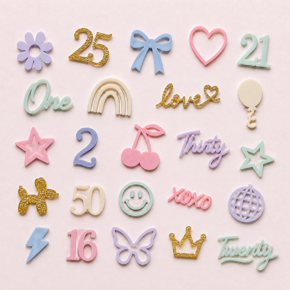 Collection of colorful decorative items including numbers, letters, and symbols on a pink background - Etch 'N' Shine
