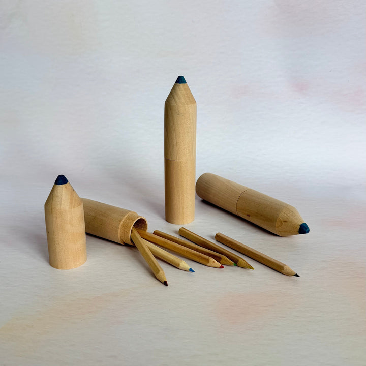 Wooden pencils with black tips on a white background
