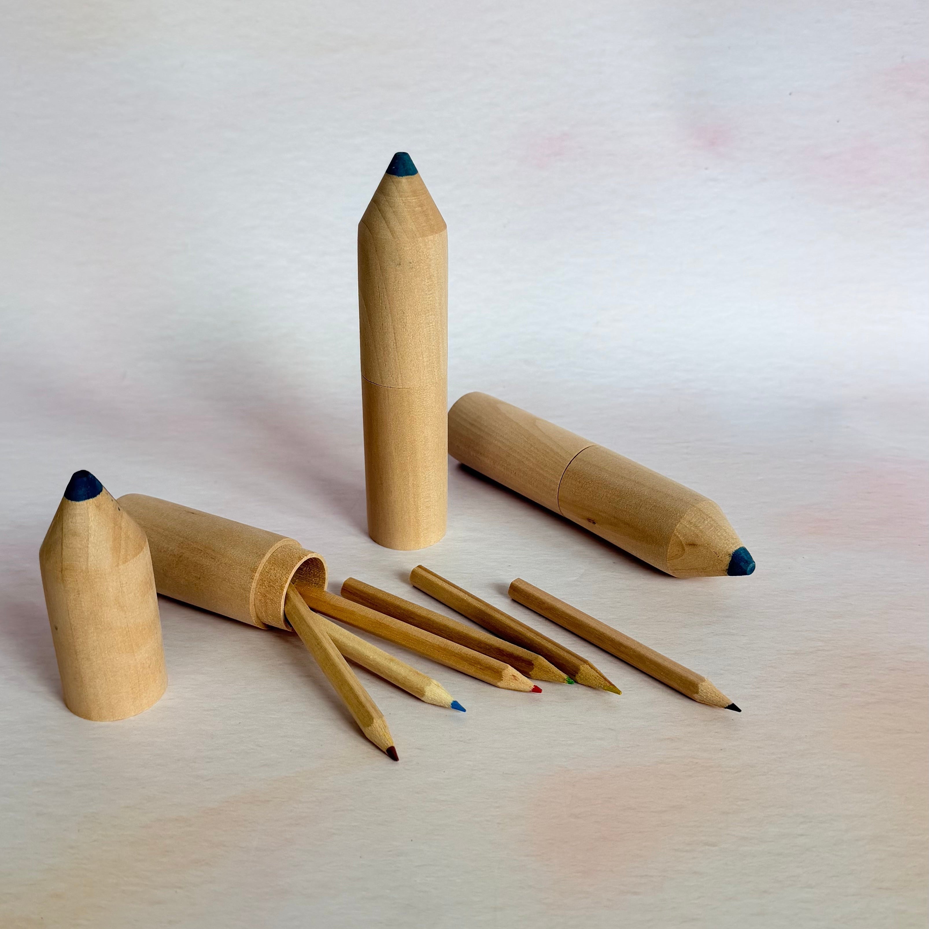 Wooden pencils with erasers on a light background